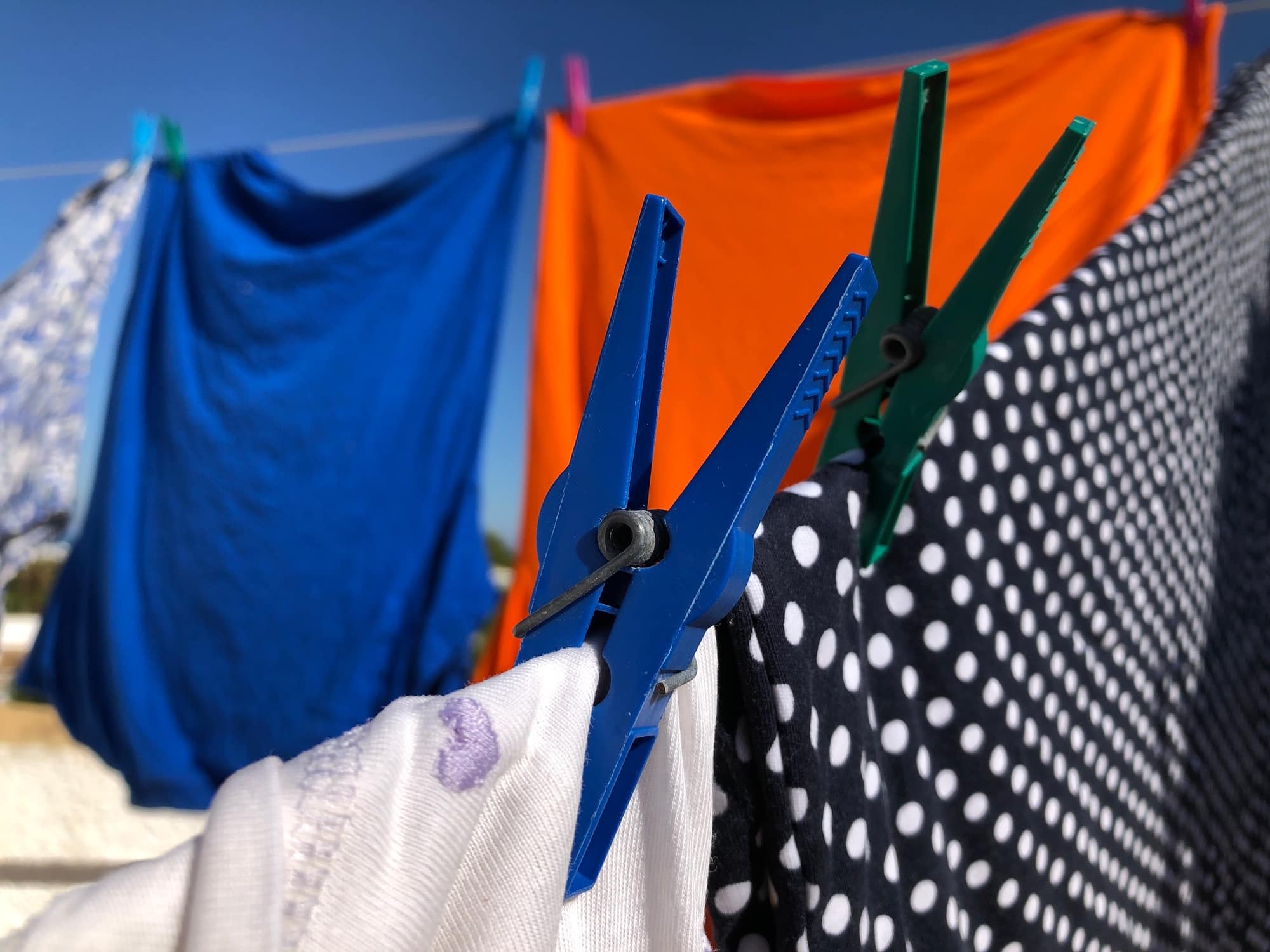 Clothes hanging out to dry on washing line outdoors in the sun.
